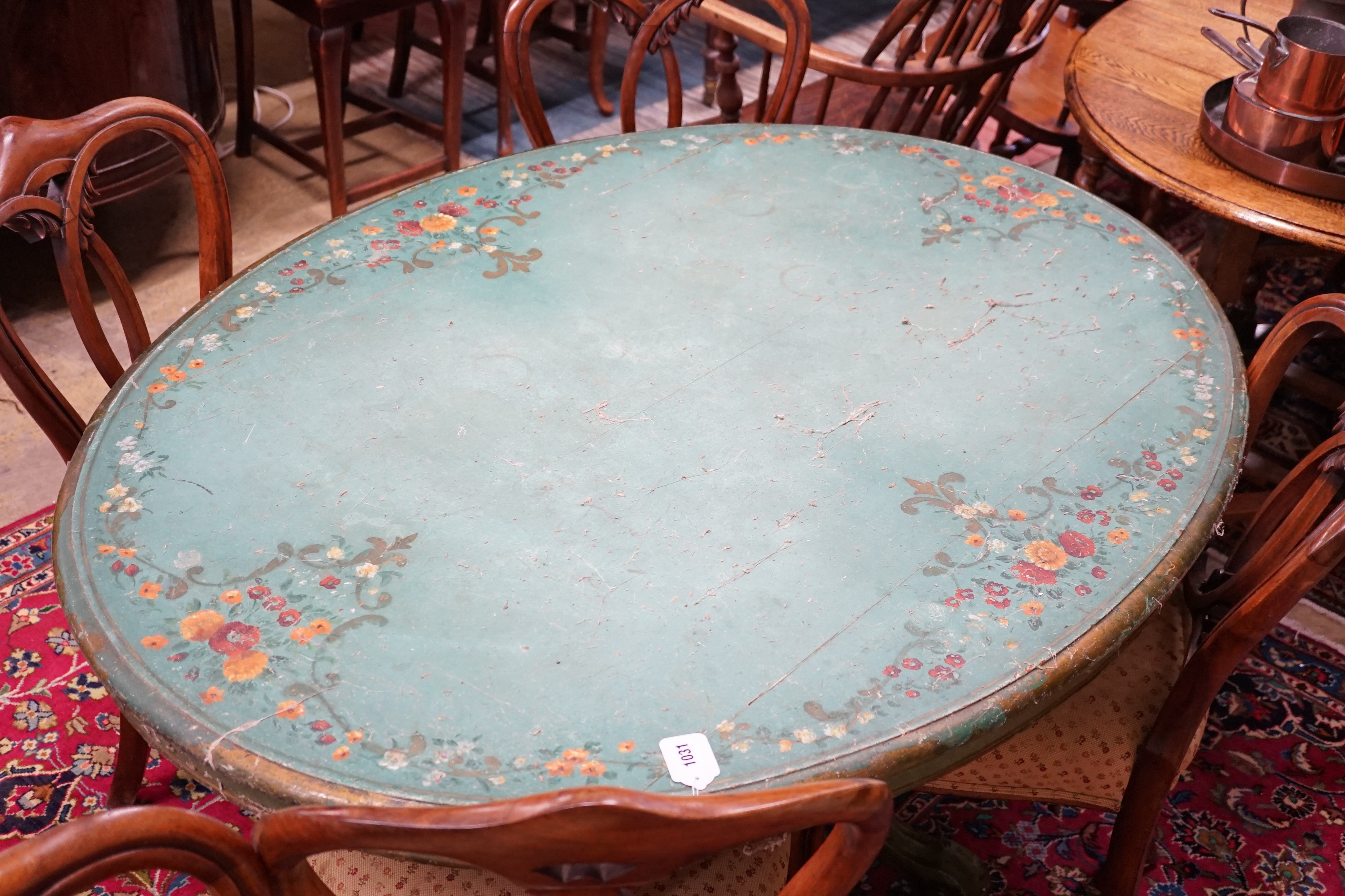 A Victorian breakfast table later painted green with floral decoration, length 143cm, depth 102cm, height 73cm